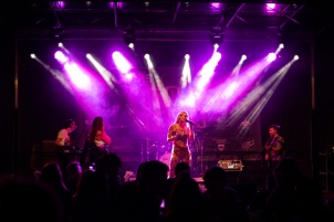 Ines Erbus performing with band at local student party.