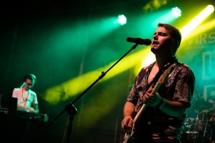 Ines Erbus performing with band at local student party.