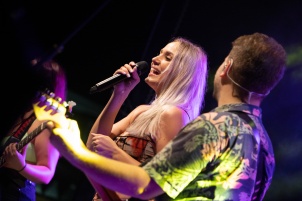 Ines Erbus performing with band at local student party.