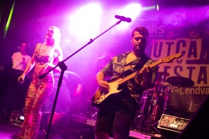 Ines Erbus performing with band at local student party.
